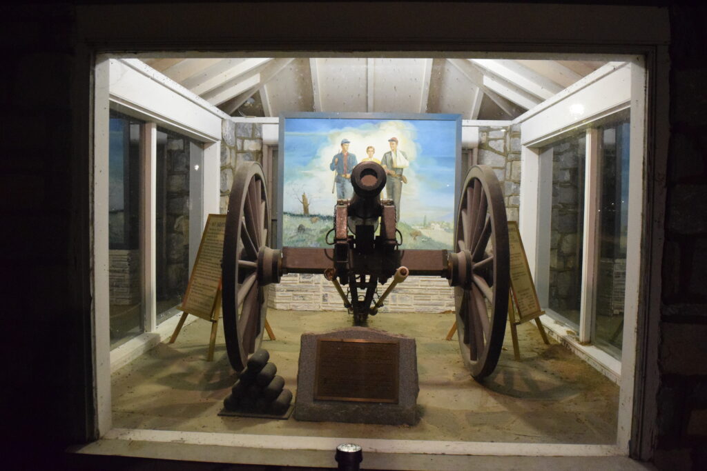 Griffen Gun cannon with Joseph Hennessy painting behind.